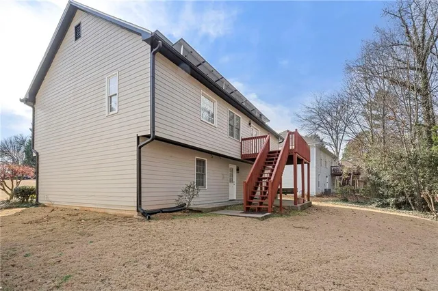 a view of a yard with wooden fence