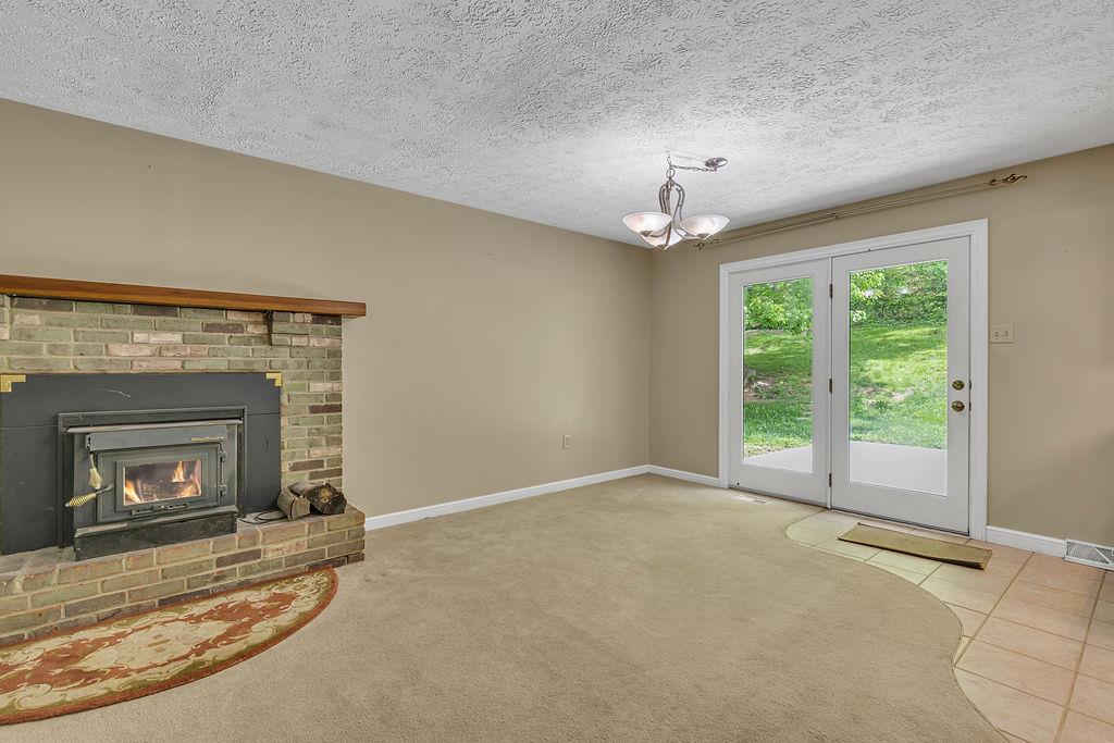 171 Dehaven Road Beaver Falls, PA 15010 - Photo 8 of 35 a view of an empty room with a fireplace and a window