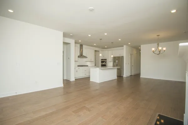 an empty room with windows and fireplace
