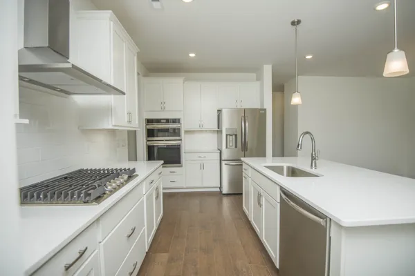 a kitchen with a sink appliances and a counter top space