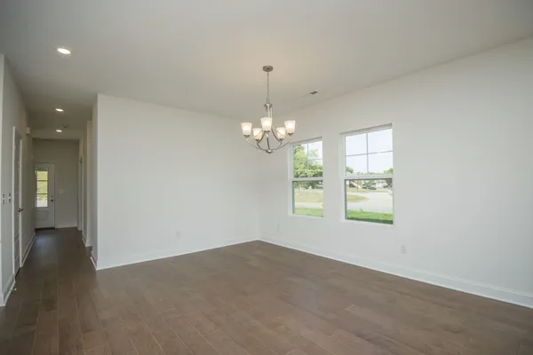 a kitchen with stainless steel appliances kitchen island granite countertop a sink a stove and a refrigerator