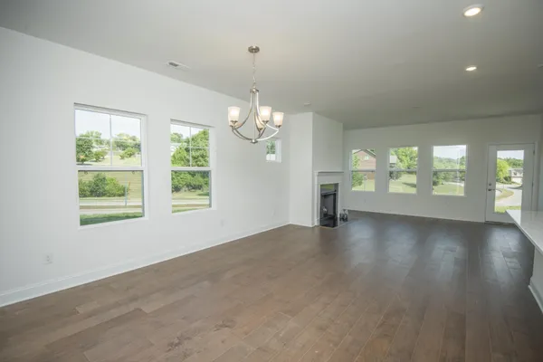 a large kitchen with a large window a sink stainless steel appliances and cabinets