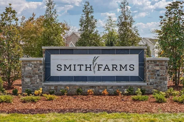 an aerial view of a house with a garden and lake view