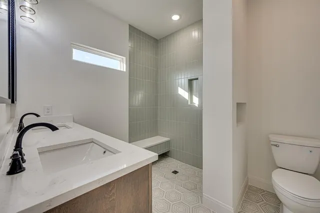 a bathroom with a sink a toilet and a mirror