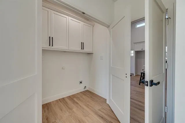 a view of a closet area with hardwood floor