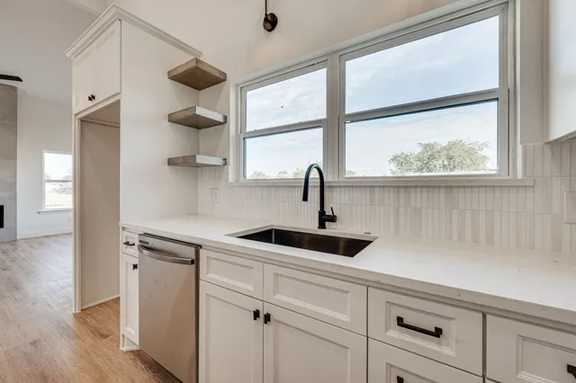 a kitchen with a sink and a window