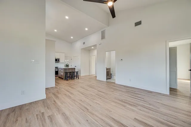 a view of a room with wooden floor and furniture