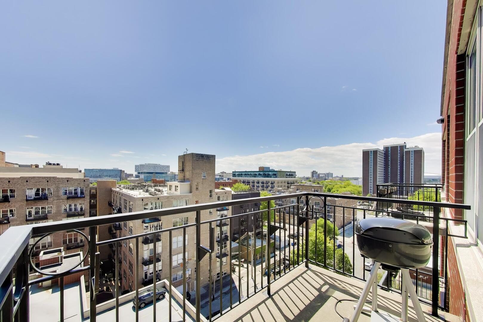 6 South Laflin Street, Unit 923 Chicago, IL 60607 - Photo 3 of 24 a view of a balcony with wooden chairs