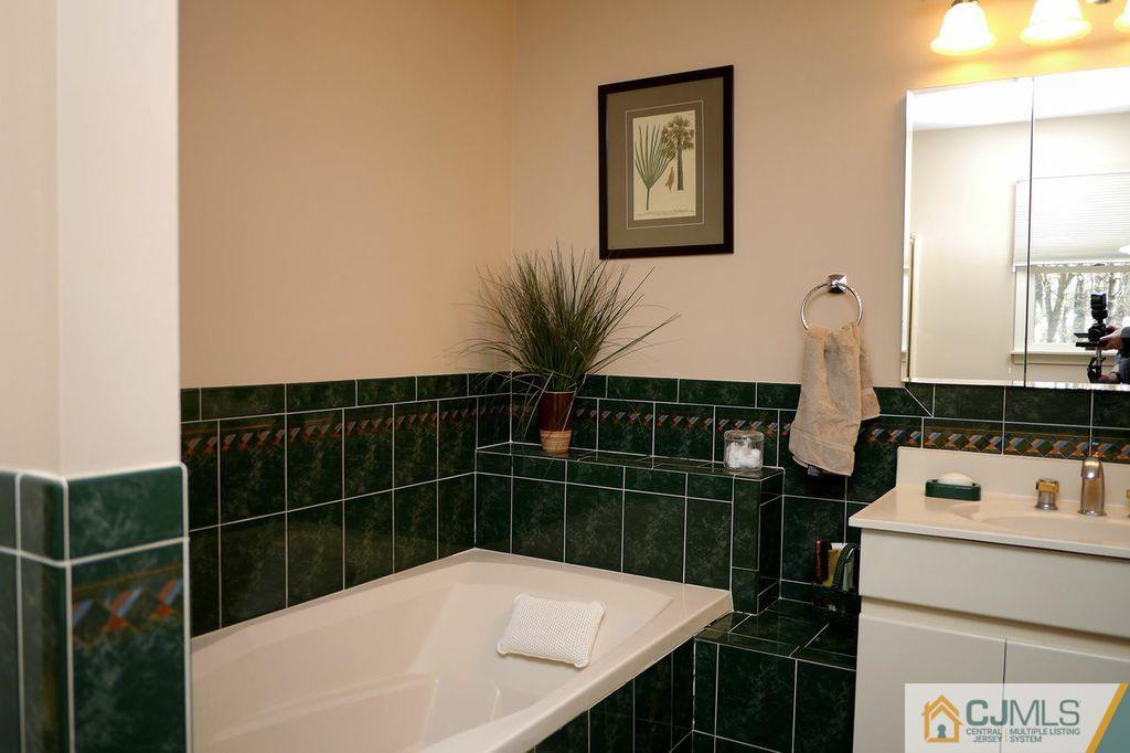 14 Bradford Road Edison, NJ 08820 - Photo 14 of 20 a bathroom with a sink toilet and shower