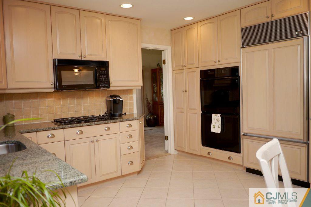 14 Bradford Road Edison, NJ 08820 - Photo 3 of 20 a kitchen with stainless steel appliances granite countertop a refrigerator and a stove top oven