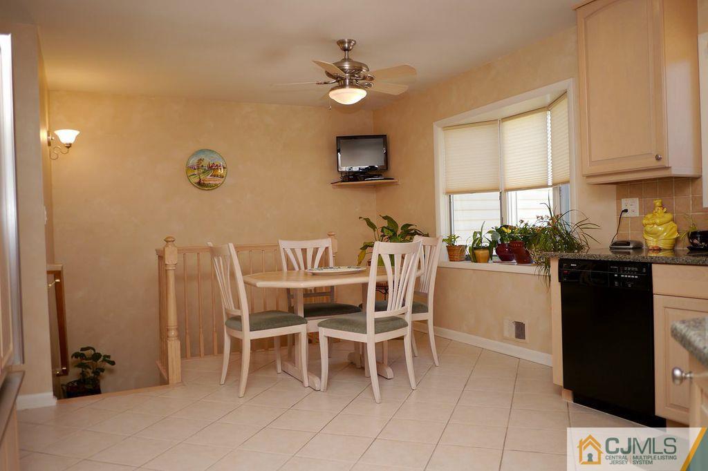 14 Bradford Road Edison, NJ 08820 - Photo 4 of 20 a dining room with furniture and a chandelier