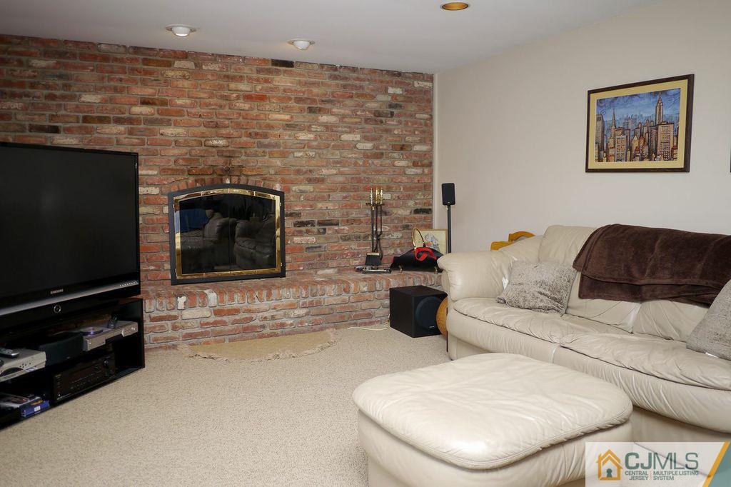 14 Bradford Road Edison, NJ 08820 - Photo 9 of 20 a living room with furniture and a fireplace