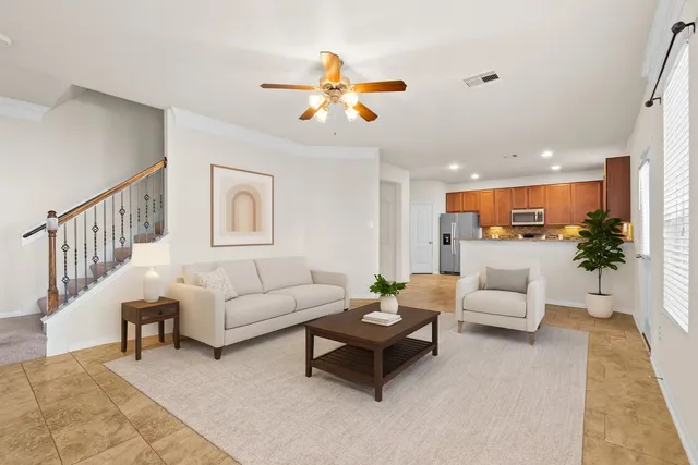 a living room with furniture and kitchen view