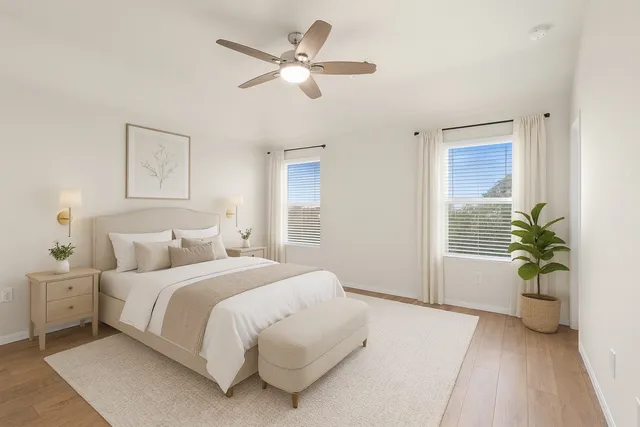 a bedroom with a large bed and a chandelier