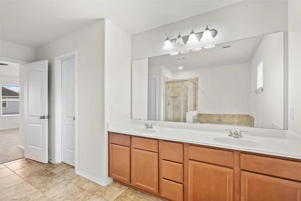 a bathroom with a double vanity sink and a mirror