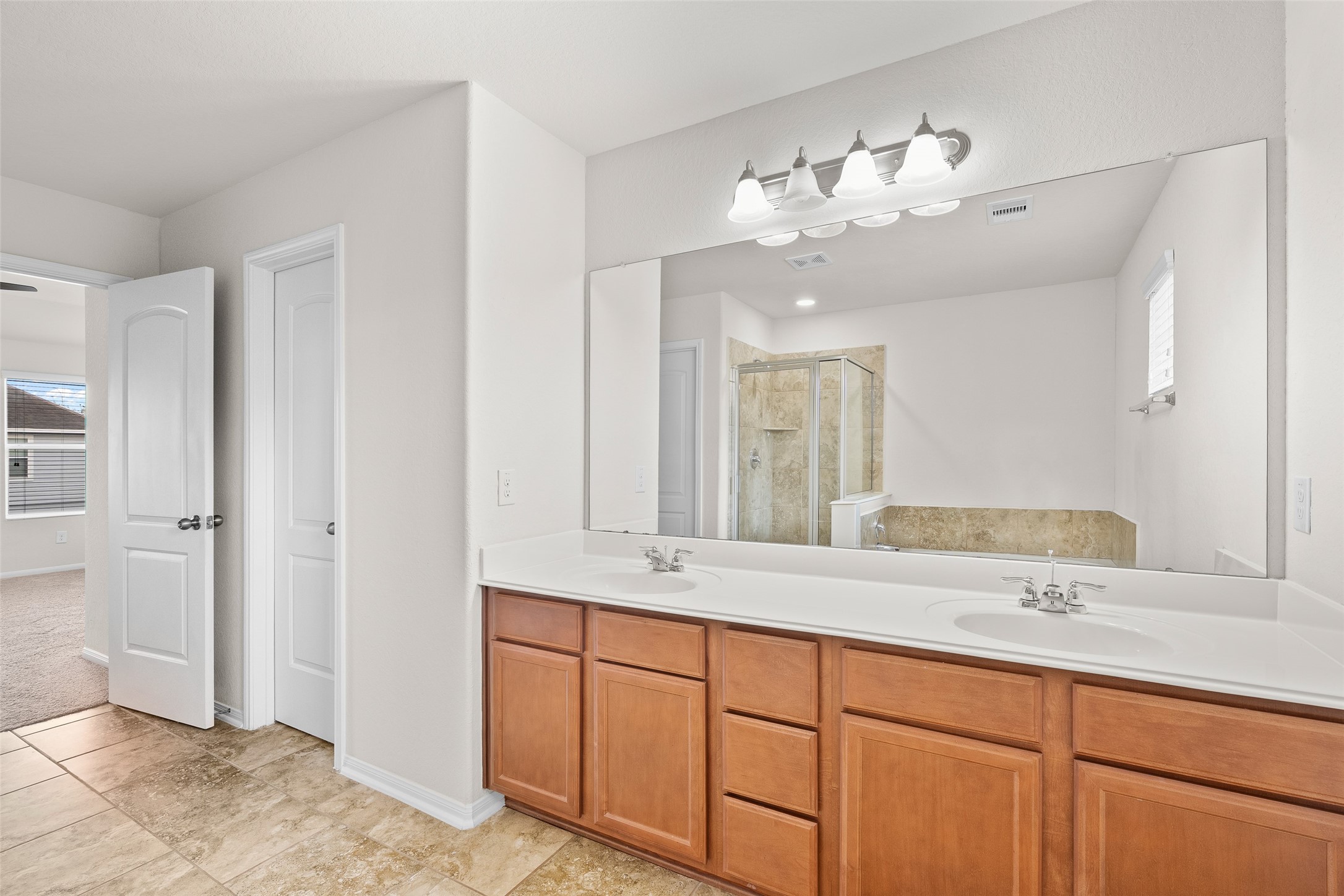 3326 Coopers Ridge Way Houston, TX 77084 - Photo 8 of 17 a bathroom with a double vanity sink and a mirror