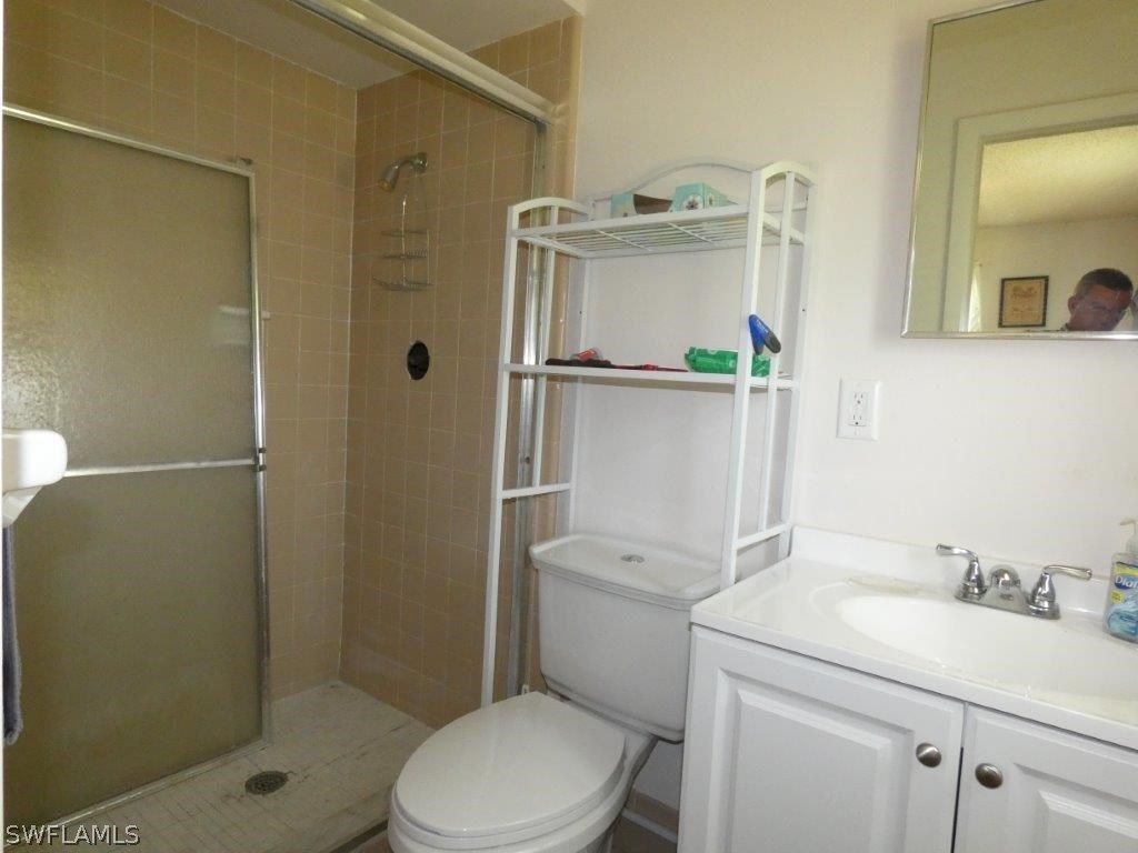 18555 Geranium Road Fort Myers, FL 33967 - Photo 18 of 25 a white toilet sitting next to a bathroom sink