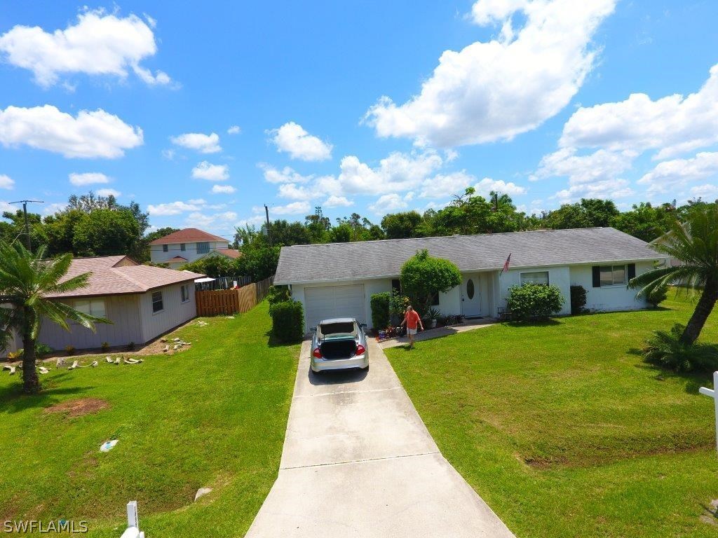 18555 Geranium Road Fort Myers, FL 33967 - Photo 3 of 25 a front view of a house with garden