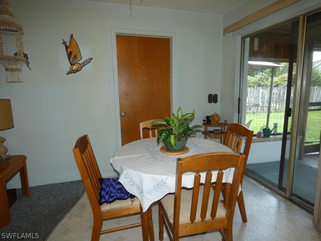 18555 Geranium Road Fort Myers, FL 33967 - Photo 7 of 25 a view of a dining room with furniture and a potted plant