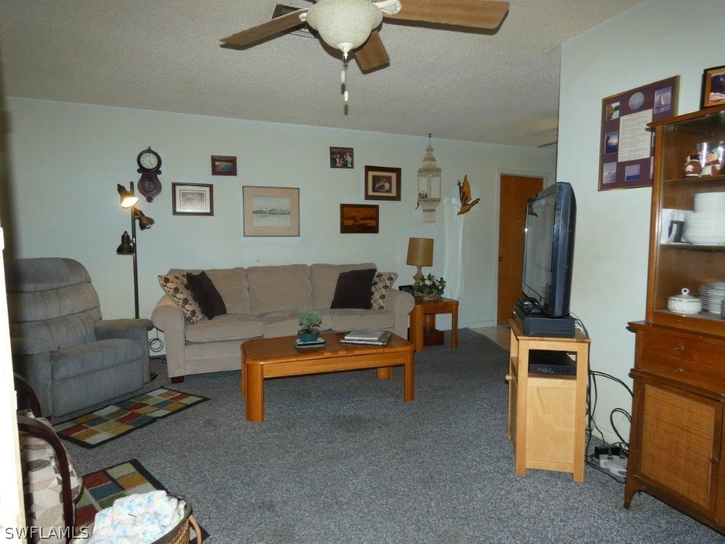 18555 Geranium Road Fort Myers, FL 33967 - Photo 9 of 25 a living room with furniture and a flat screen tv