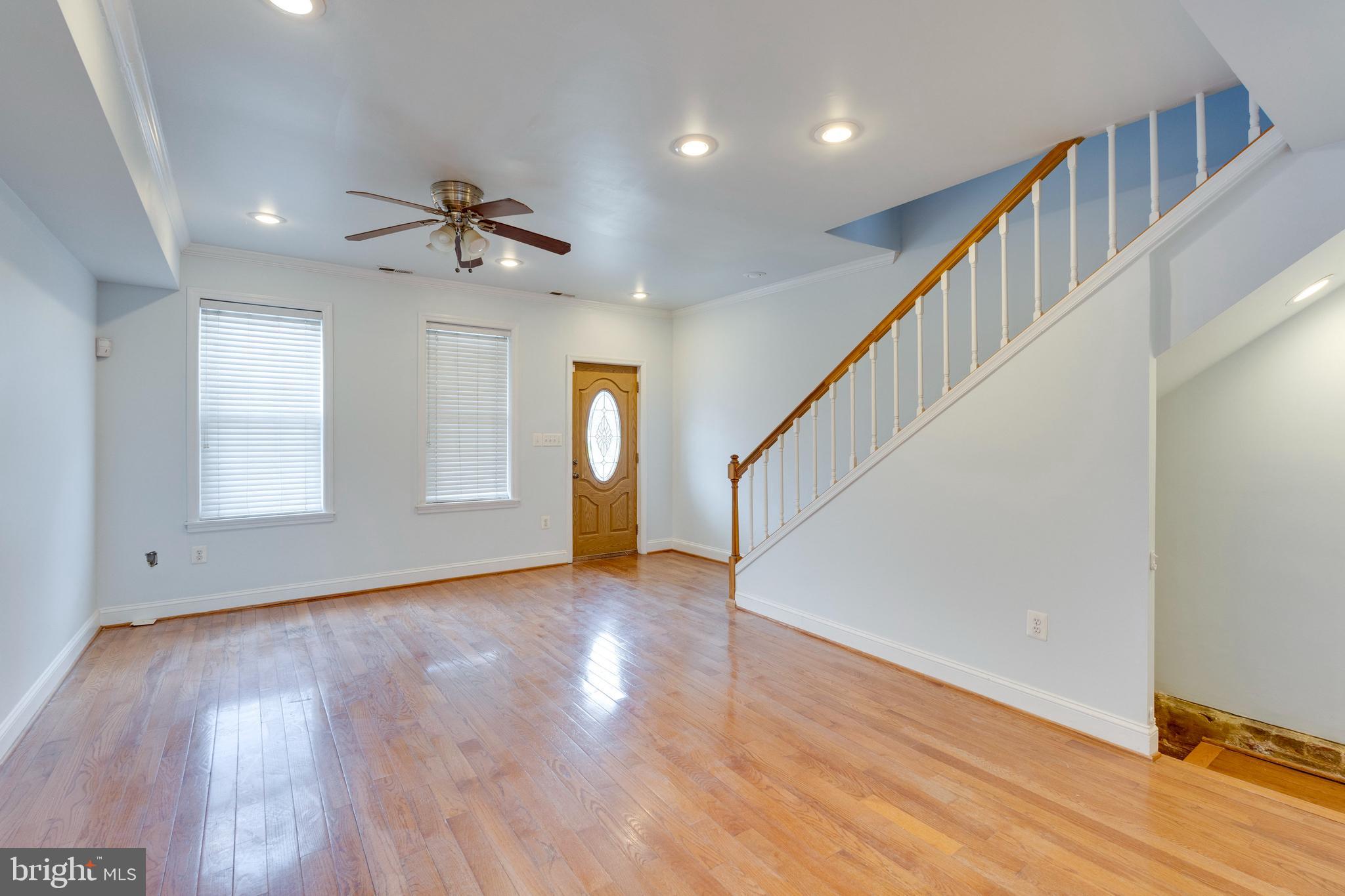 3017 Warder Street Northwest Washington, DC 20001 - Photo 3 of 14 a view of an empty room with wooden floor and stairs