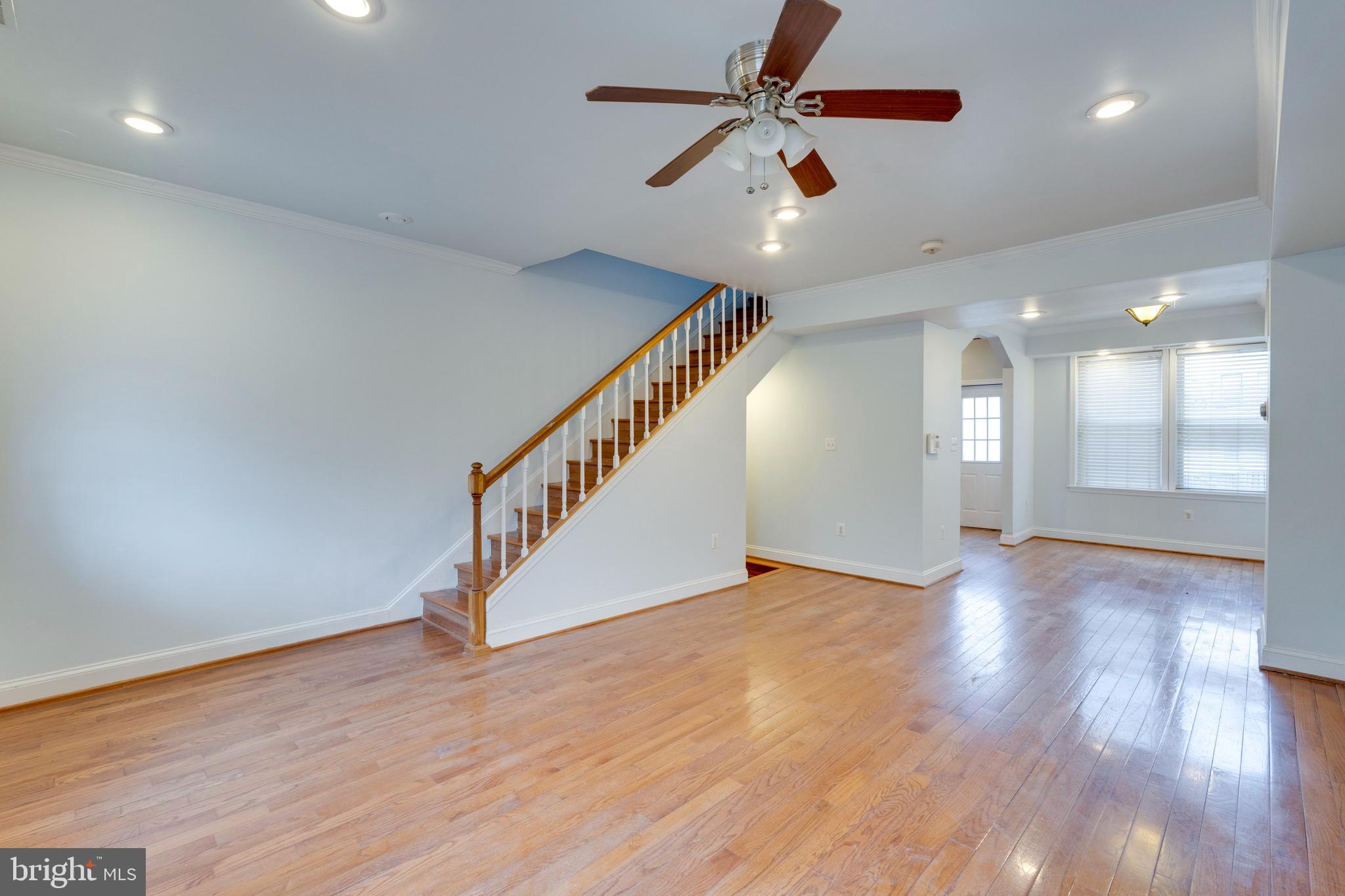 3017 Warder Street Northwest Washington, DC 20001 - Photo 4 of 14 an empty room with wooden floor fan and windows