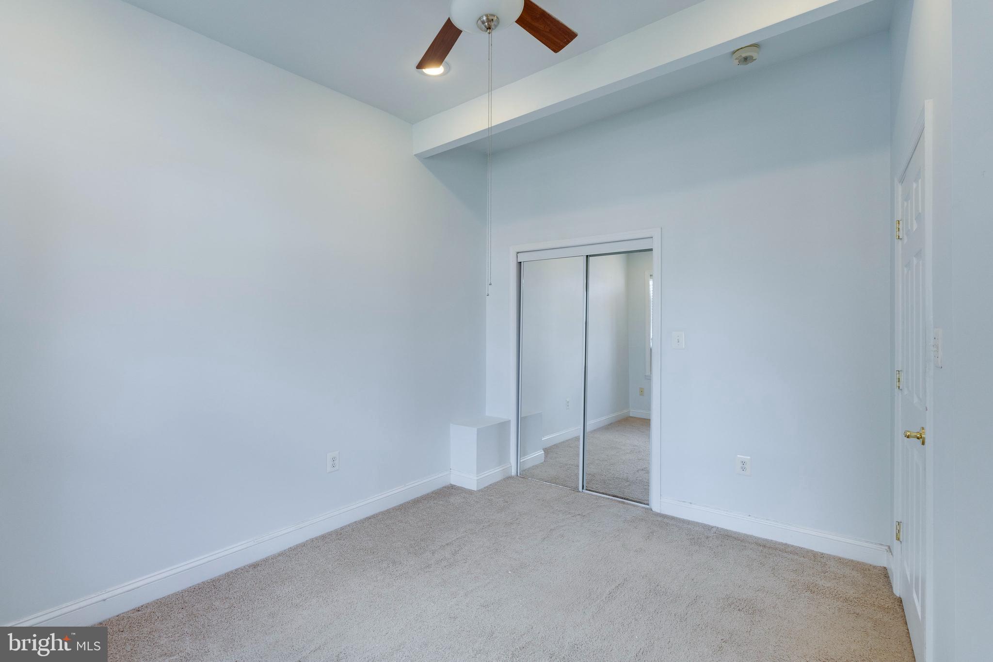 3017 Warder Street Northwest Washington, DC 20001 - Photo 9 of 14 an empty room with closet and fan