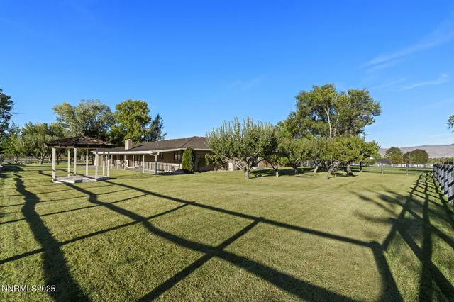 a view of a swimming pool with an outdoor seating and a mountain view