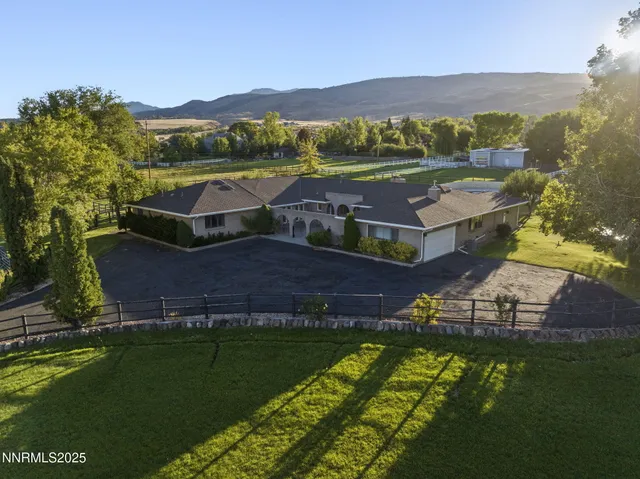 an aerial view of residential houses with outdoor space and river