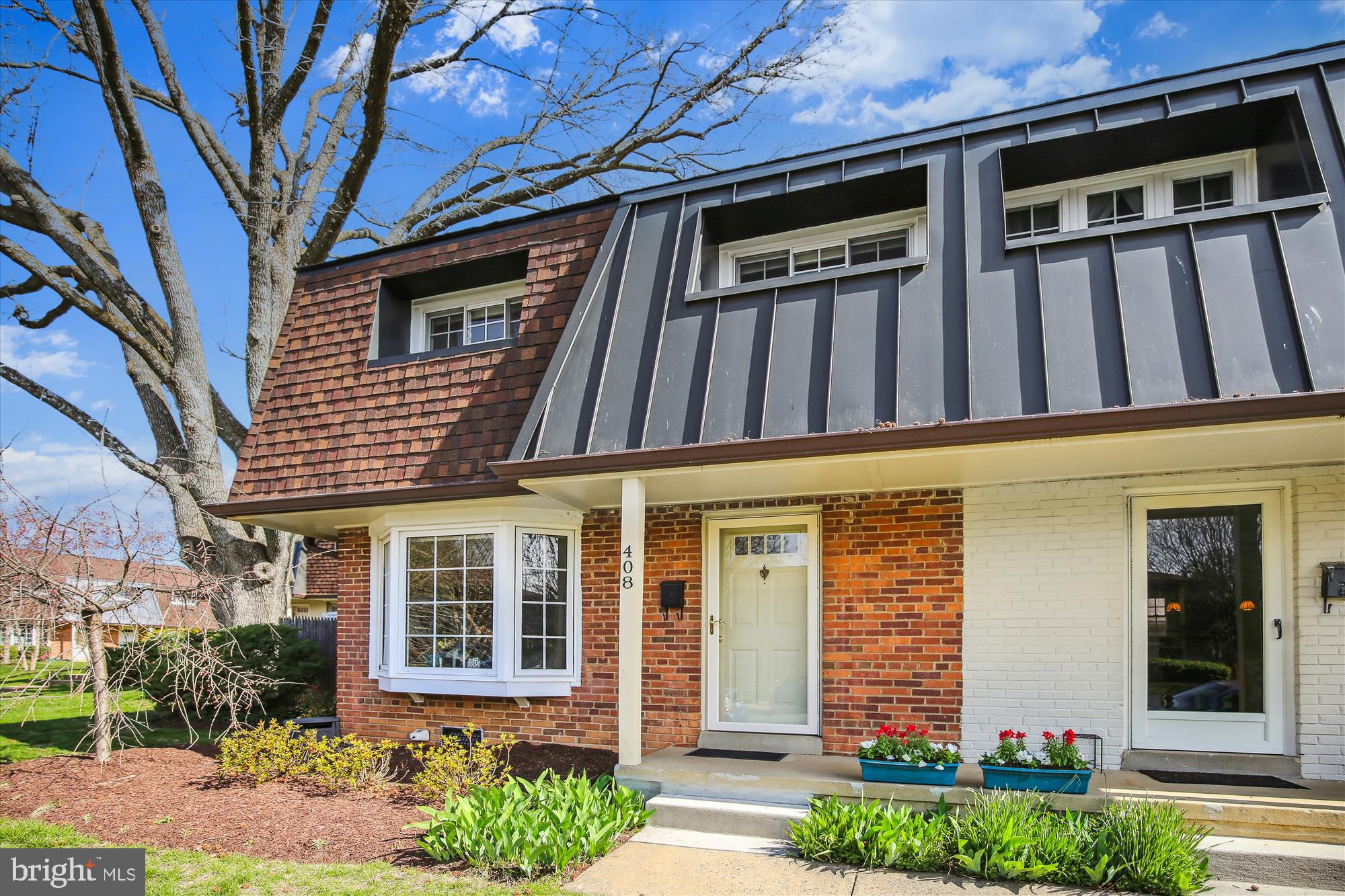 a front view of a house with a yard outdoor seating and garage