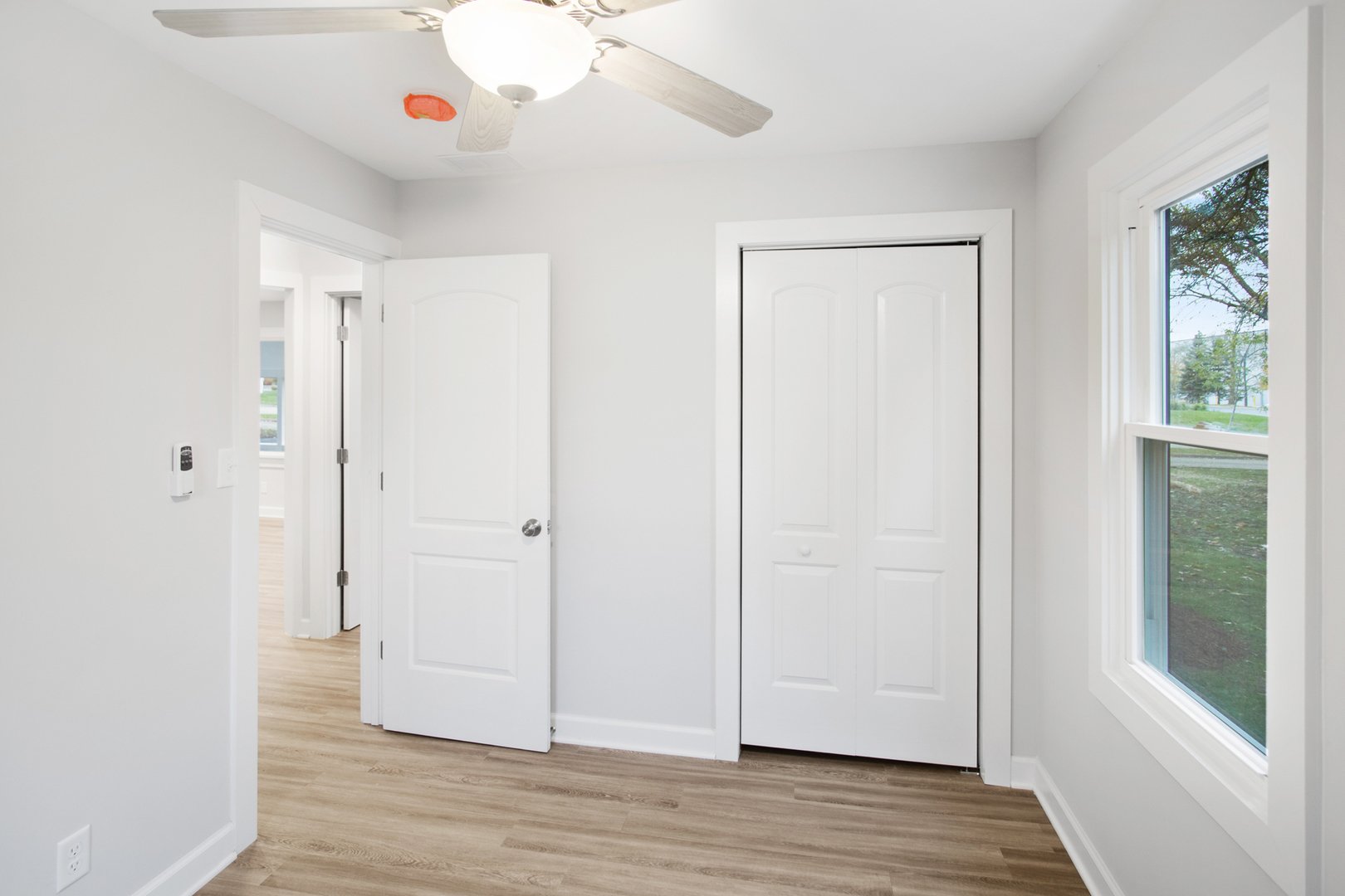 715 Anthony Trail Northbrook, IL 60062 - Photo 13 of 20 a view of an empty room with wooden floor and a window