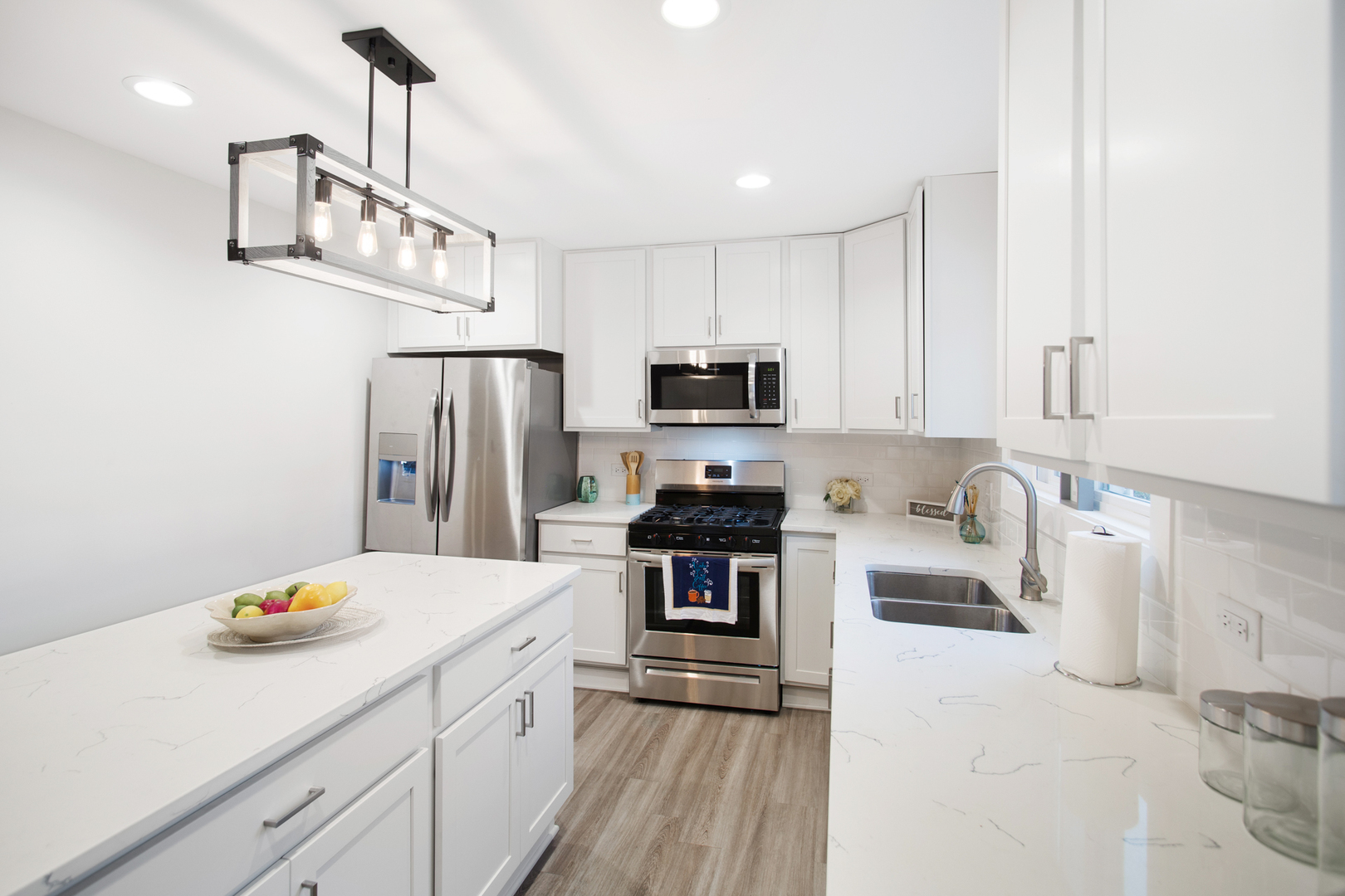715 Anthony Trail Northbrook, IL 60062 - Photo 3 of 20 a kitchen with stainless steel appliances a refrigerator a stove a sink dishwasher a oven with white cabinets and wooden floor