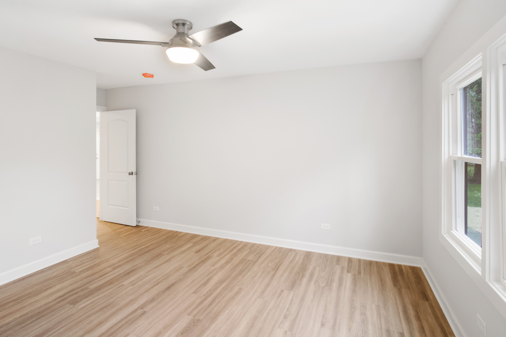 715 Anthony Trail Northbrook, IL 60062 - Photo 8 of 20 wooden floor in an empty room with a window