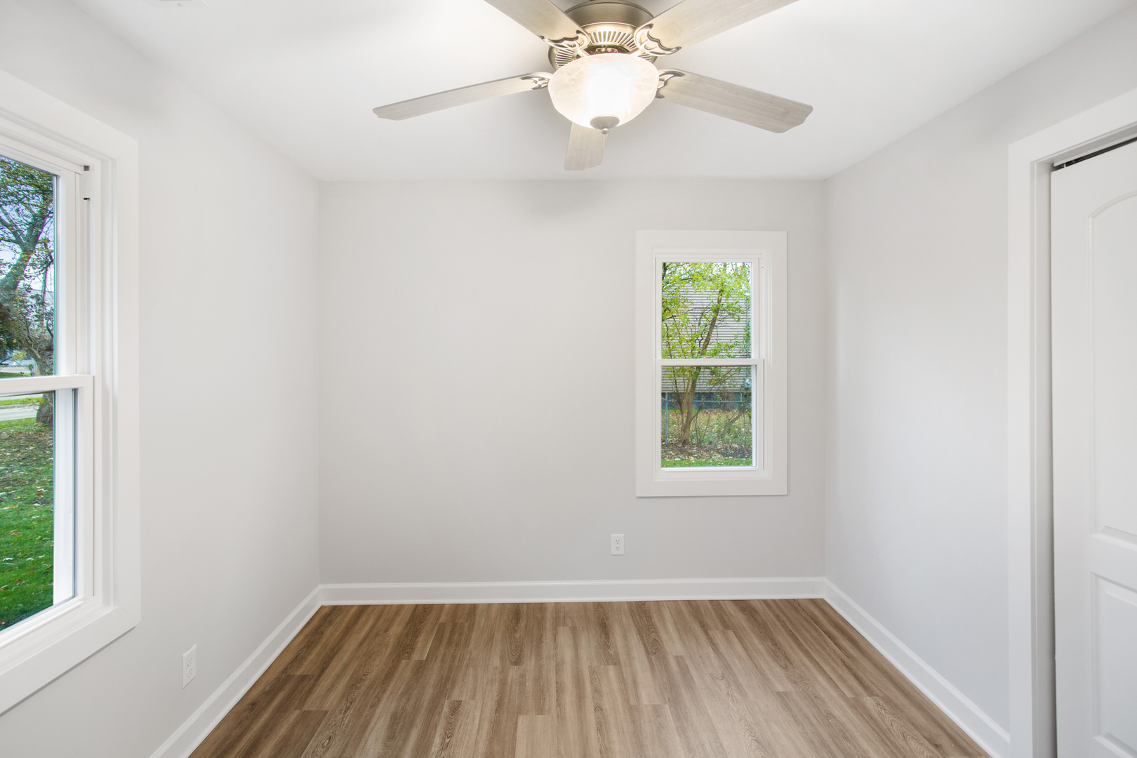 715 Anthony Trail Northbrook, IL 60062 - Photo 10 of 20 a view of an empty room with wooden floor and a window