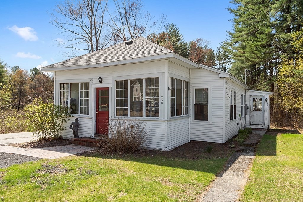 250 Brookside Road Orange, MA 01364 - Photo 1 of 30 a view of a white house with a large garden