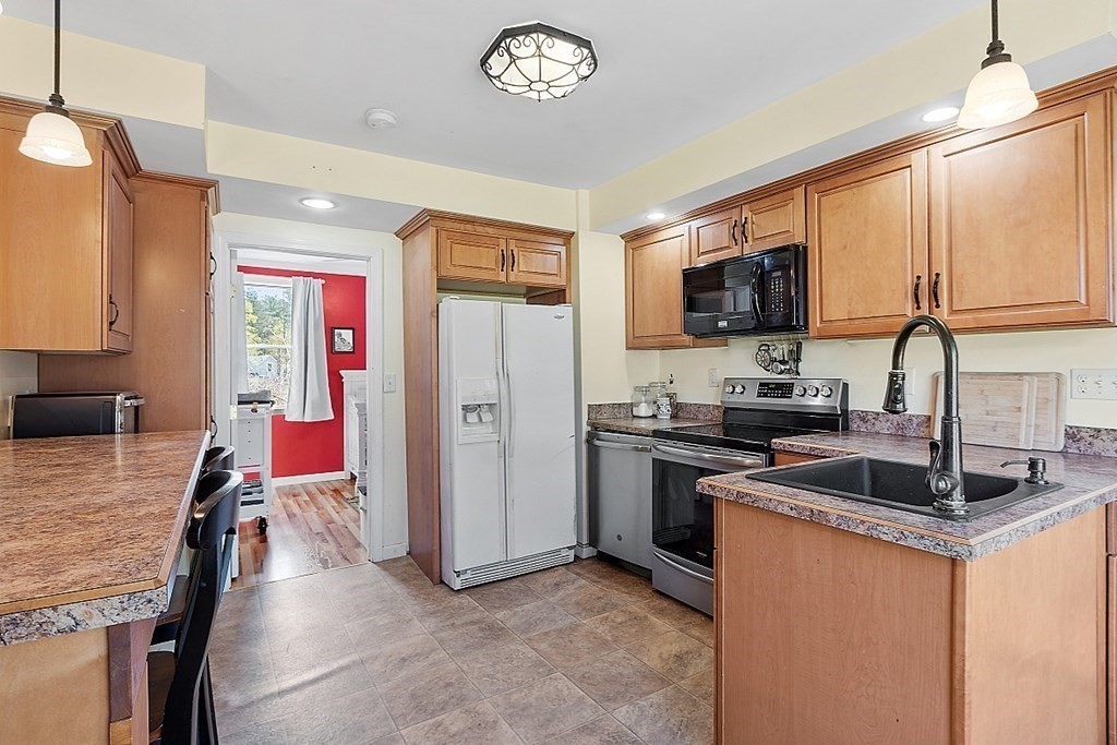 250 Brookside Road Orange, MA 01364 - Photo 13 of 30 a kitchen with stainless steel appliances granite countertop a stove refrigerator sink and dishwasher