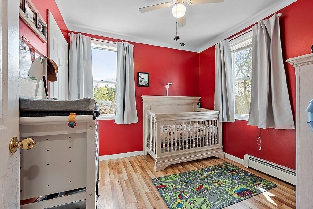 250 Brookside Road Orange, MA 01364 - Photo 18 of 30 a bedroom with a bed and wooden floor