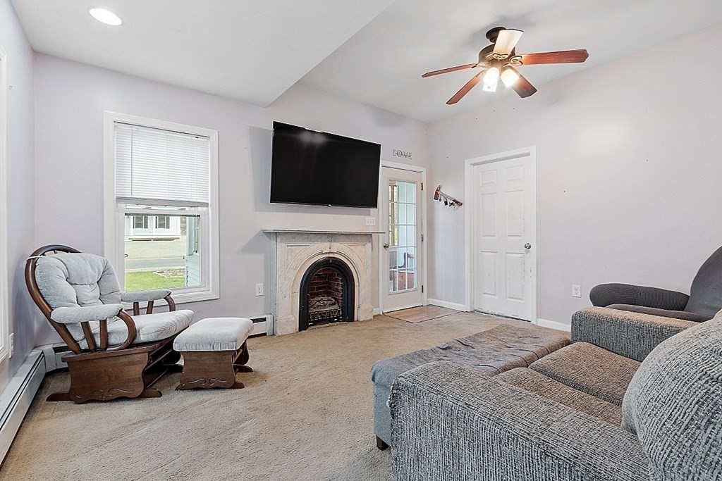 250 Brookside Road Orange, MA 01364 - Photo 8 of 30 a spacious bedroom with a bed a couch and a flat screen tv