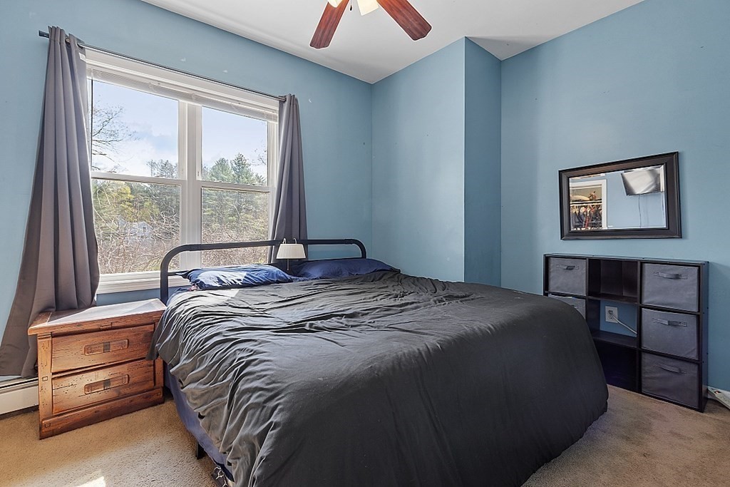 250 Brookside Road Orange, MA 01364 - Photo 9 of 30 a bedroom with a bed and a large window