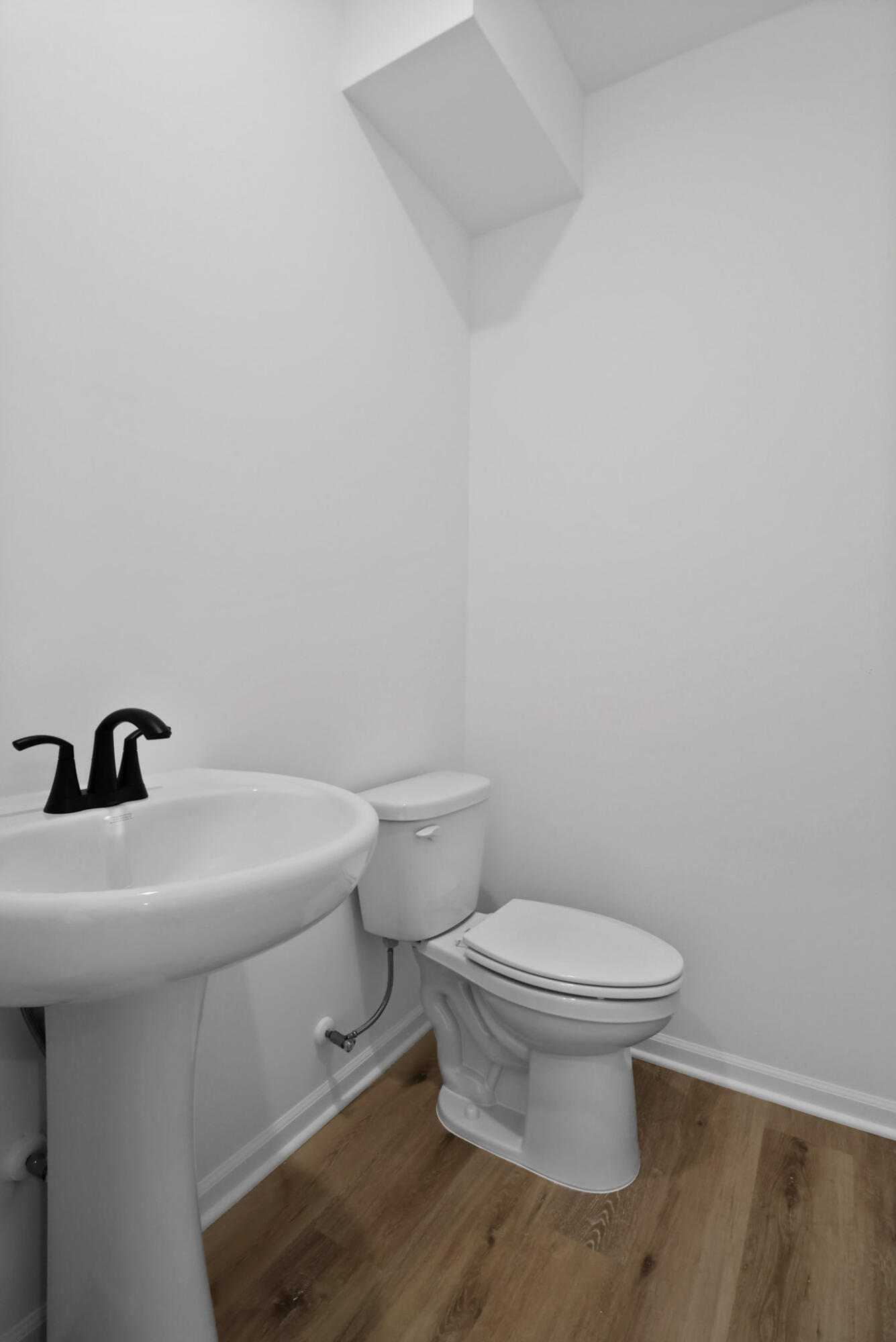 10410 California Street Crown Point, IN 46307 - Photo 19 of 24 a white toilet sitting next to a white sink