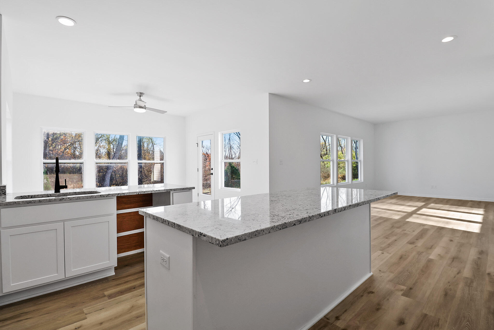 10410 California Street Crown Point, IN 46307 - Photo 5 of 24 a open kitchen with granite countertop a sink and dishwasher with wooden floor