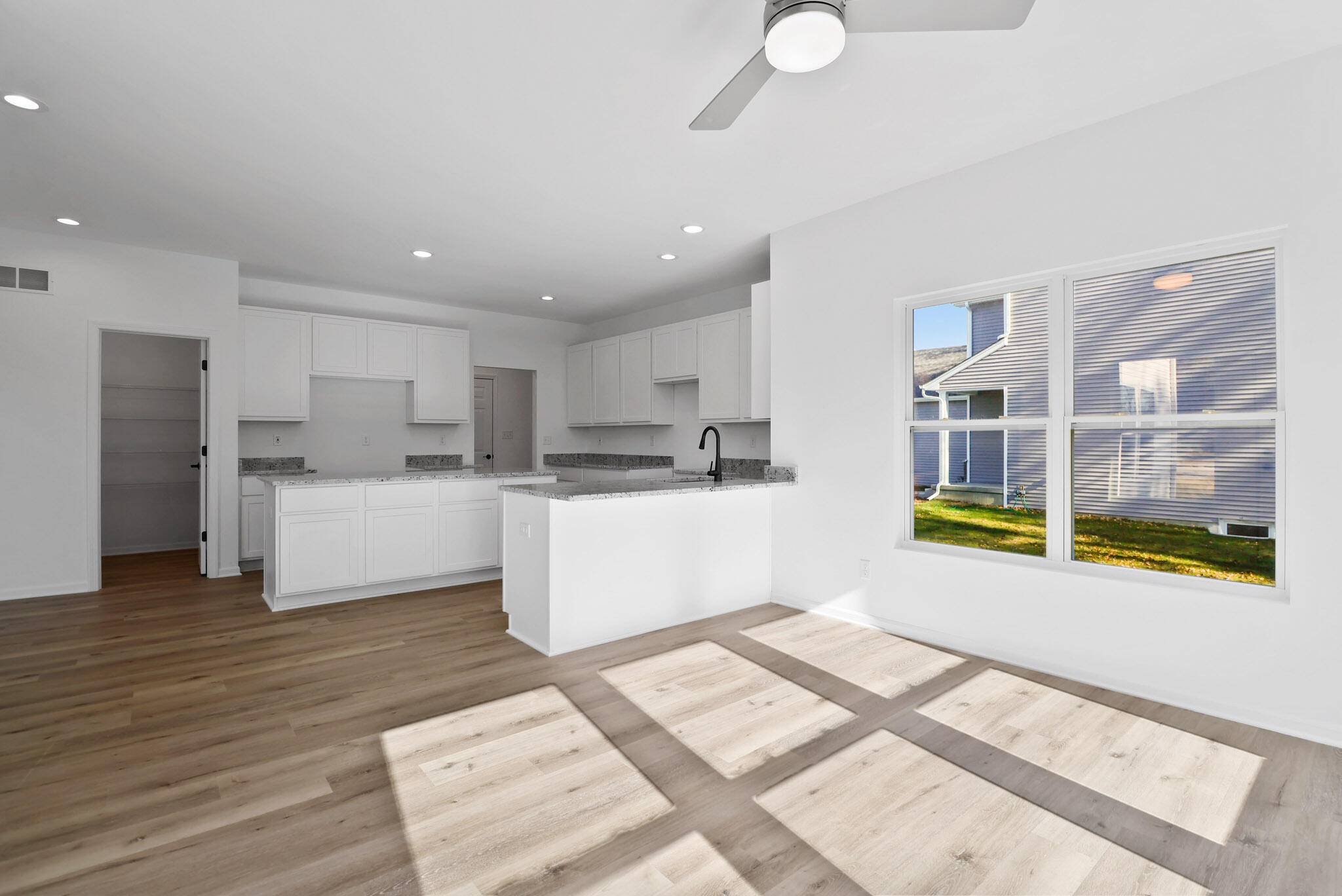 10410 California Street Crown Point, IN 46307 - Photo 7 of 24 a living room with stainless steel appliances kitchen island granite countertop a refrigerator and a sink