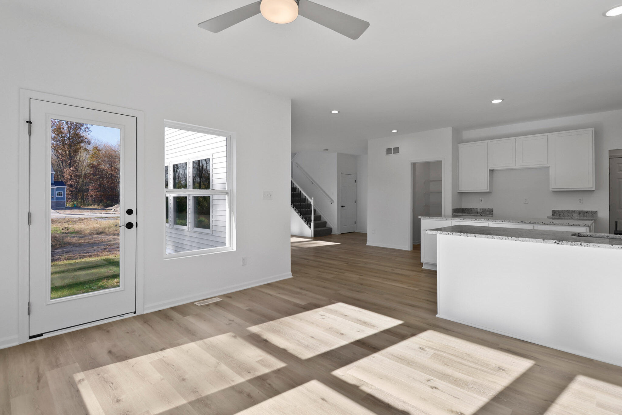 10410 California Street Crown Point, IN 46307 - Photo 8 of 24 a open kitchen with white cabinets and wooden floor