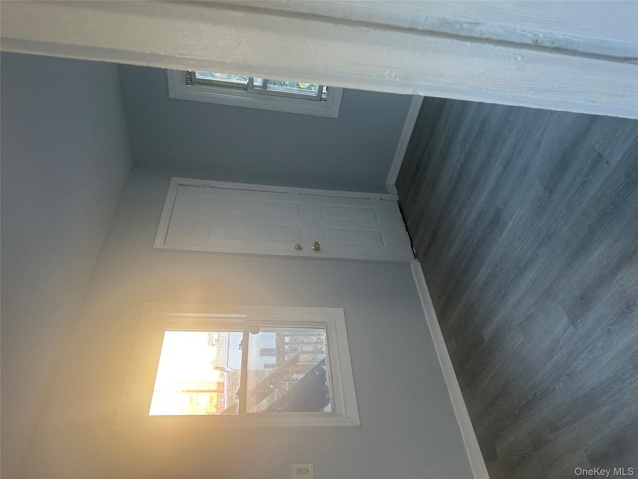 4 Ritters Lane Yonkers, NY 10703 - Photo 13 of 41 an empty room with wooden floor and windows