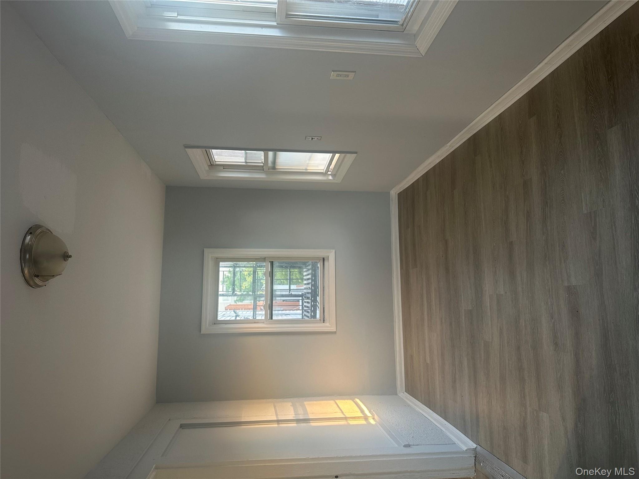 4 Ritters Lane Yonkers, NY 10703 - Photo 14 of 41 an empty room with wooden floor and windows