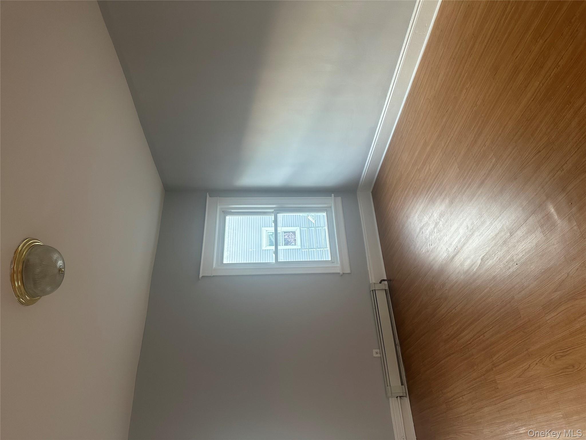 4 Ritters Lane Yonkers, NY 10703 - Photo 22 of 41 an empty room with wooden floor and windows