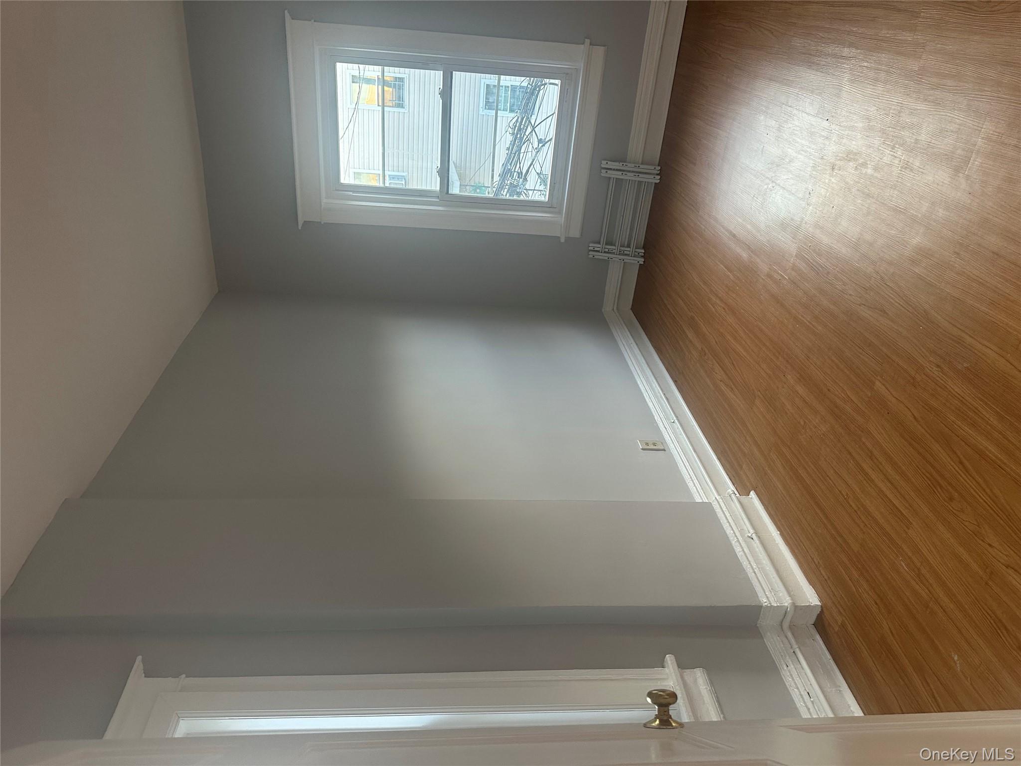 4 Ritters Lane Yonkers, NY 10703 - Photo 23 of 41 an empty room with wooden floor and windows