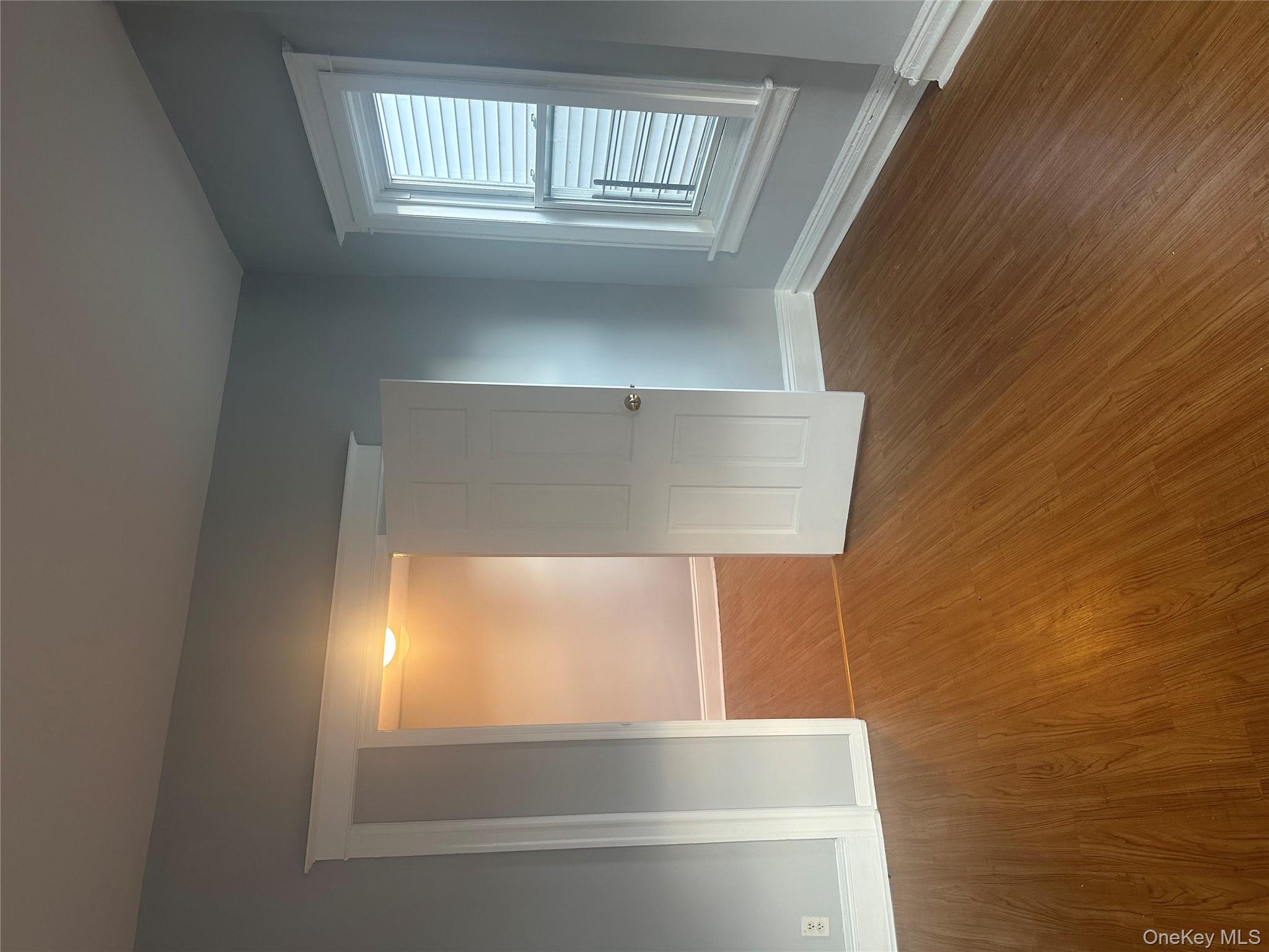 4 Ritters Lane Yonkers, NY 10703 - Photo 25 of 41 an empty room with wooden floor and windows