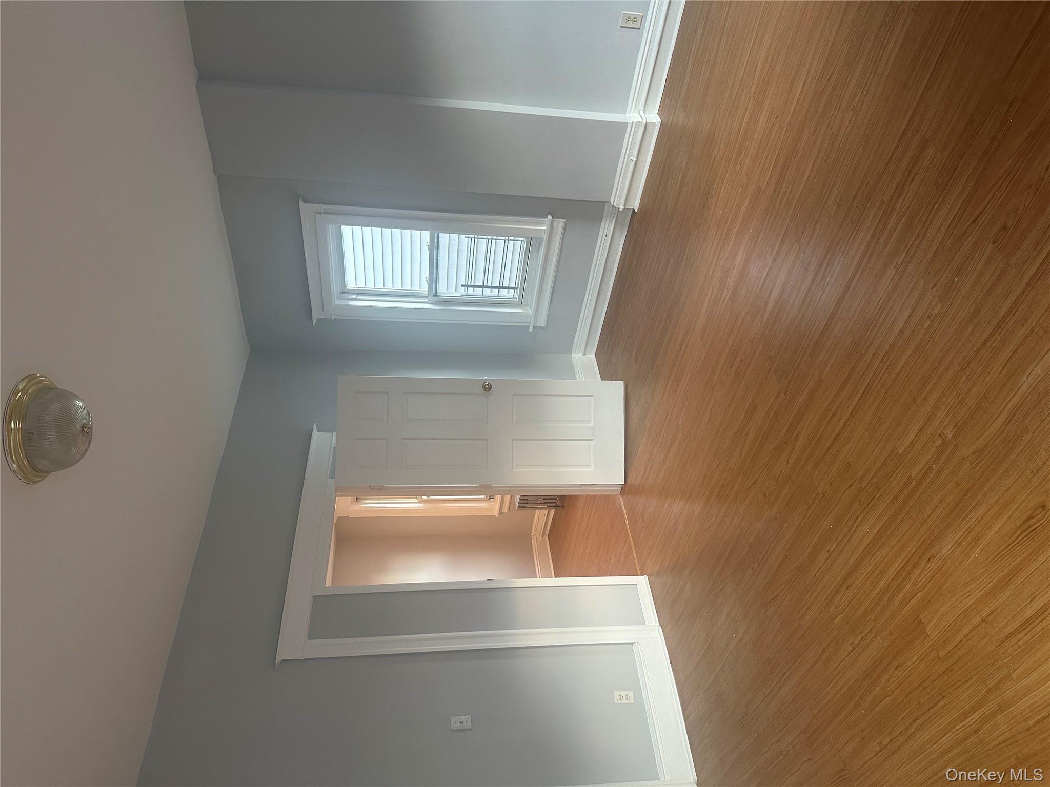 4 Ritters Lane Yonkers, NY 10703 - Photo 26 of 41 an empty room with wooden floor and windows