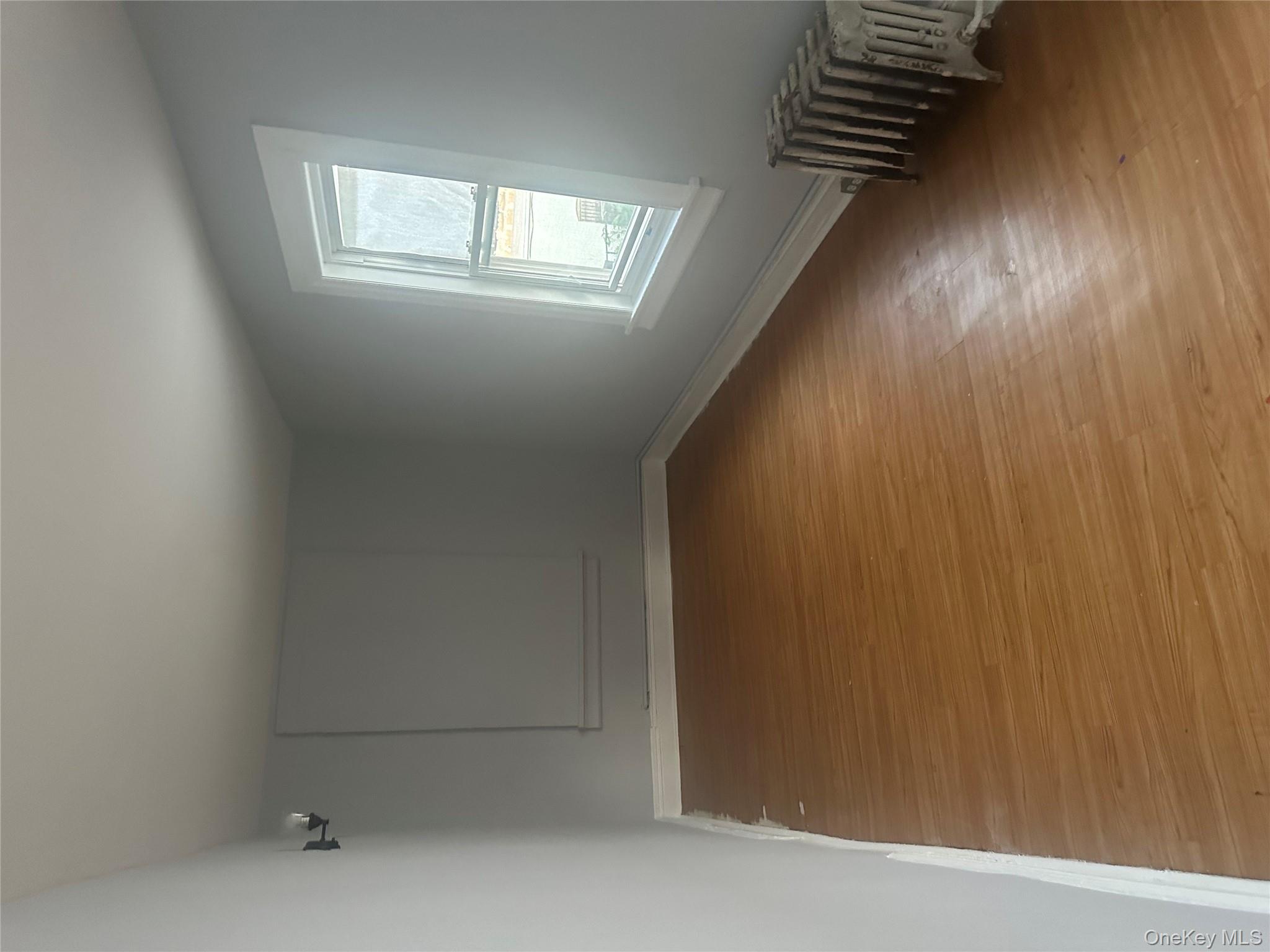 4 Ritters Lane Yonkers, NY 10703 - Photo 28 of 41 an empty room with wooden floor and windows